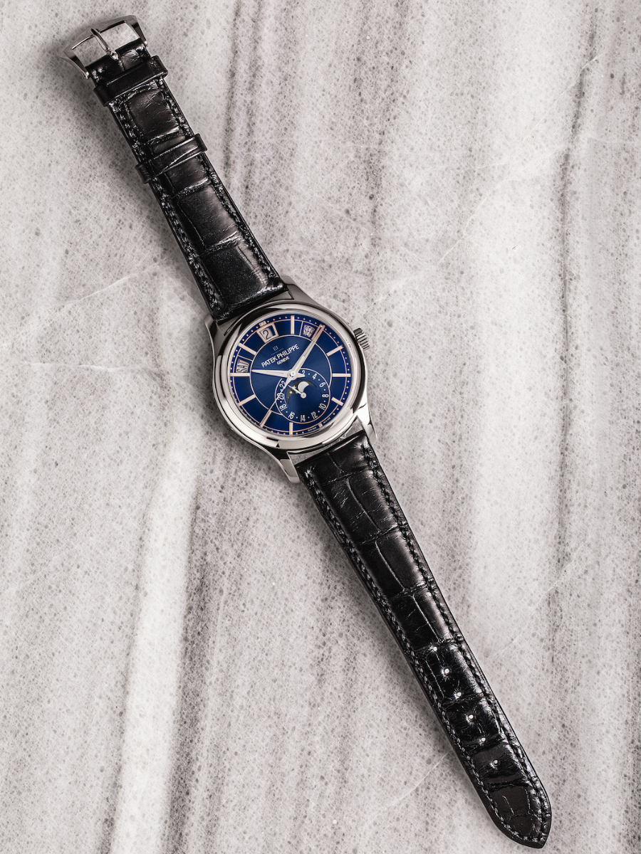 Featuring an annual calendar and moon phase, the Patek Philippe 5205G-013 combines blue dial, and black alligator strap