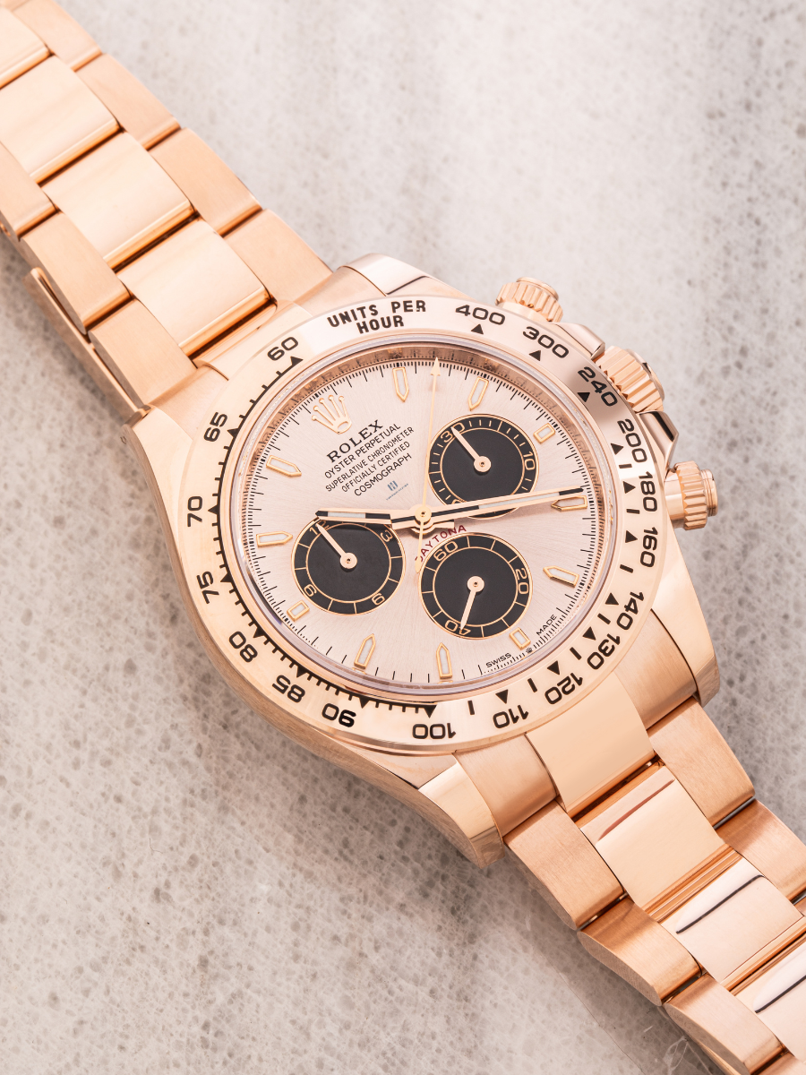 Rolex Daytona 126505 watch in rose gold, featuring a tachymeter bezel, a light-colored dial with contrasting black subdials, a date window, and an Oyster bracelet