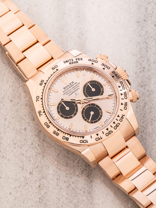 Rolex Daytona 126505 watch in rose gold, featuring a tachymeter bezel, a light-colored dial with contrasting black subdials, a date window, and an Oyster bracelet