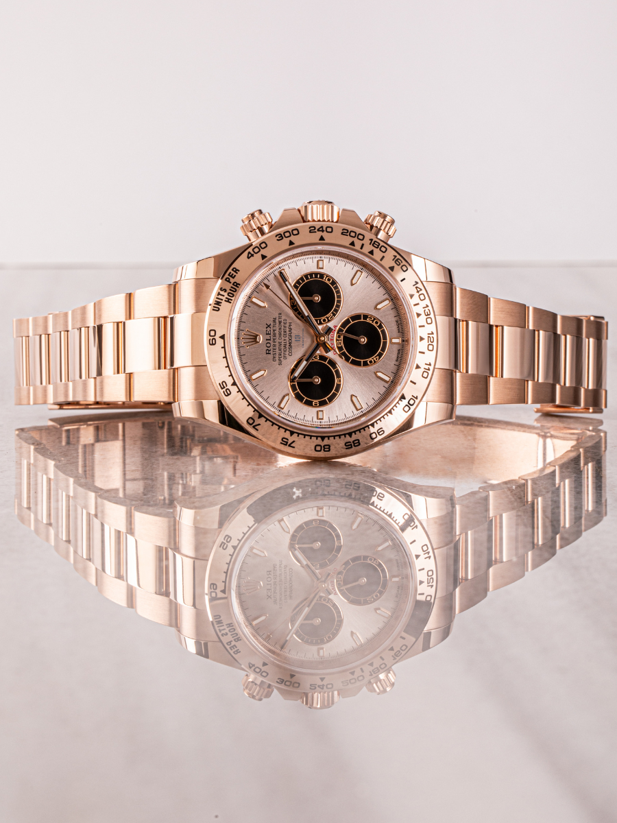 Rolex Daytona 126505 on a reflective surface showcasing dial details, complications, tachymeter scale, and mirrored image