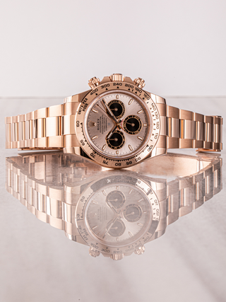 Rolex Daytona 126505 on a reflective surface showcasing dial details, complications, tachymeter scale, and mirrored image