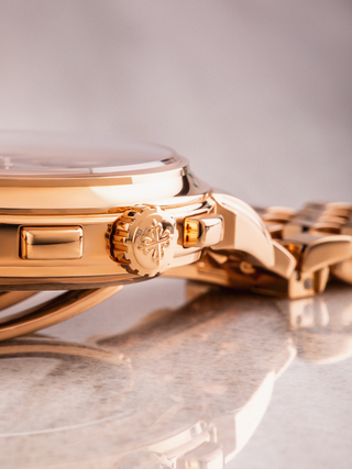 Patek Philippe 5270/1 is placed on marble floor with the crown and the logo on focus