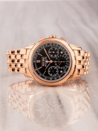 Patek Philippe 5270/1R placed horizontally on a marble floor