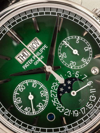 The enlarged view highlights the Laquered greendial of Patek Philippe 5270P with black-gradient rim