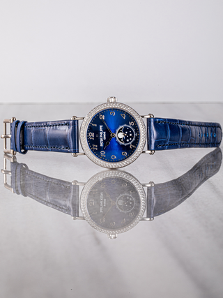 Luxurious Patek Philippe watch with a sleek royal blue dial and stylish silver case.