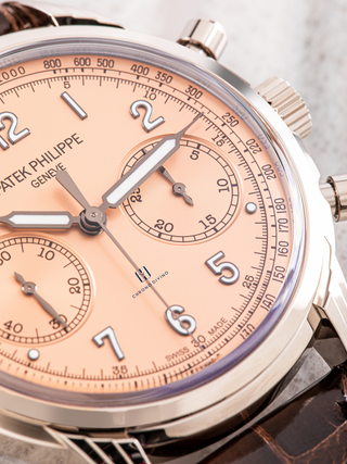 Close-up of Patek Philippe 5172G with its rose-gilt opaline dial, showcasing applied Arabic numerals, luminescent gold hands