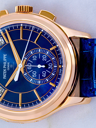 The image is on the right side view of Patek Philippe watch’s  blue belt and the portion of the blue dial