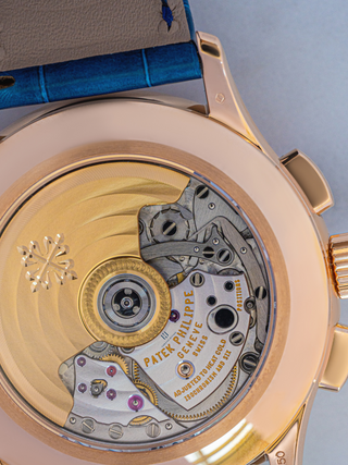 The enlarged view of Patek Philippe Geneve watch with blue strap has been shown in the picture