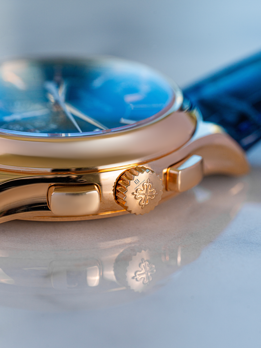 The image is focused on the crown of Patek Philippe 5905R watch, embossing Chrono Divino logo