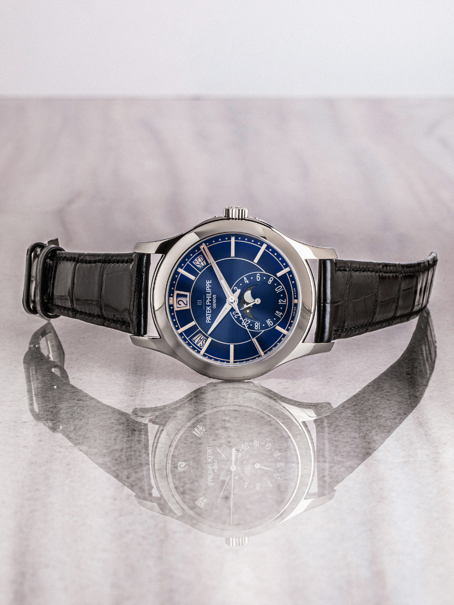 Patek Philippe 5205G-013 showcasing annual calendar, moon phase, white gold case has been represented in the image