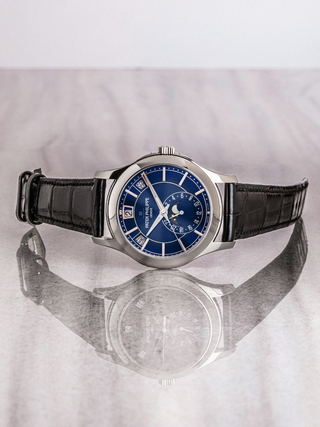Patek Philippe 5205G-013 showcasing annual calendar, moon phase, white gold case has been represented in the image
