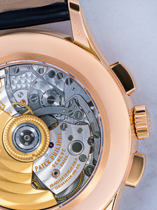 Close-up of Patek Philippe 5905R-001 dial with rose gold crown and pusher, featuring a brown sunray gradient