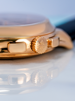 The image is focused on the crown of Patek Philippe 5905R watch, with Chrono Divino logo embossing