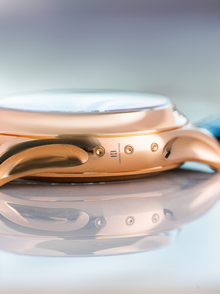 The picture represents the side view of Patek Philippe 5905R watch with Chrono Divino logo