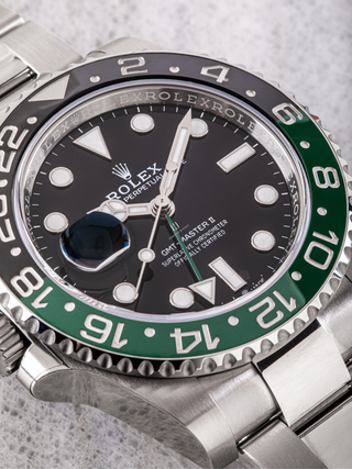 Detailed view of Rolex GMT Master II 126720VTNR with a black and green ceramic bezel and black dial