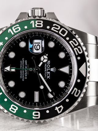 Rolex GMT Master II 126720VTNR featuring the iconic Mercedes hands and the cyclops lens magnifying the date
