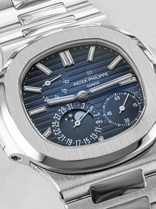 The dark blue dial of silver Patek Philippe 5712/1A placed diagonally