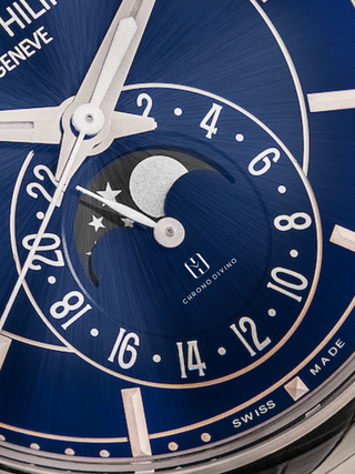 The zoomed-in picture highlights the Blue sunburst dial with the silver embellished moon phase