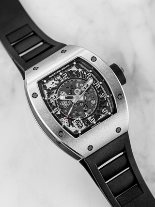 A black Richard Mille RM 010 is visible in the picture