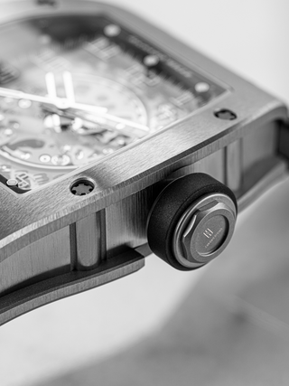 The crown of Richard Mille RM 010 with the Chrono Divino logo on the picture