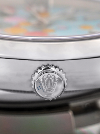 Detailed view of a Rolex crown with branding, fluting, and watchmaking precision