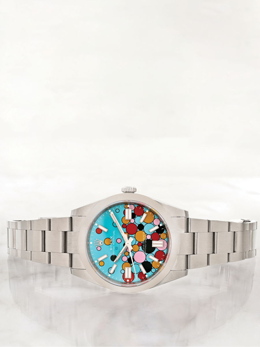 Rolex Oyster Perpetual 41 with "Celebration" dial, colorful bubbles design, smooth bezel, and oyster bracelet, on a light background