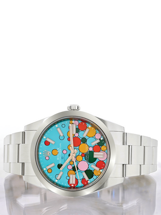Front view of a Rolex Oyster Perpetual dial, showcasing the stainless steel case and bracelet, the light blue dial with the colorful bubbles