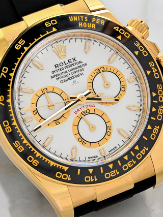 Yellow Gold Rolex Daytona with a white dial, gold subdials, a date window, "SWISS MADE" visible at the bottom of the dial