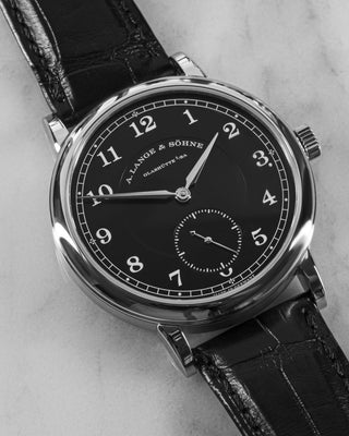 A. Lange & Söhne 1815 200th Anniversary watch in platinum with a matte black dial and glossy leather strap.