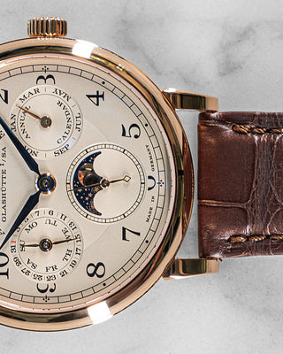 Front view of A. Lange & Söhne 1815 Annual Calendar watch featuring silver dial, white gold case, and elegant blued steel hands.