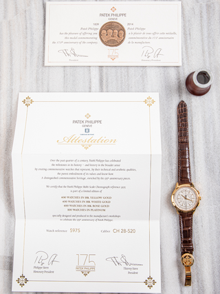 Classic Patek Philippe watch with a sleek white dial and stainless steel case.