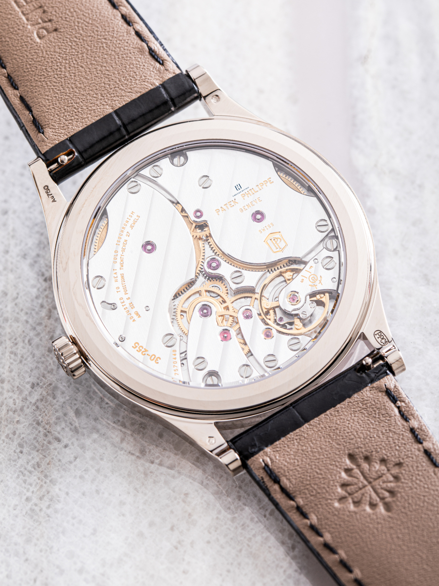The back of Patek Philippe 6119G with a transparent case revealing all the gears
