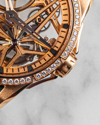 Elegant Roger Dubuis Excalibur DBEX0566 watch featuring rose gold case, diamond bezel, and classic leather strap – front-facing product image.