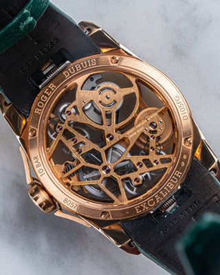 Front view of Roger Dubuis DBEX0566 watch in 18k rose gold, featuring a sunray-finished dial, diamond bezel, and polished lugs.