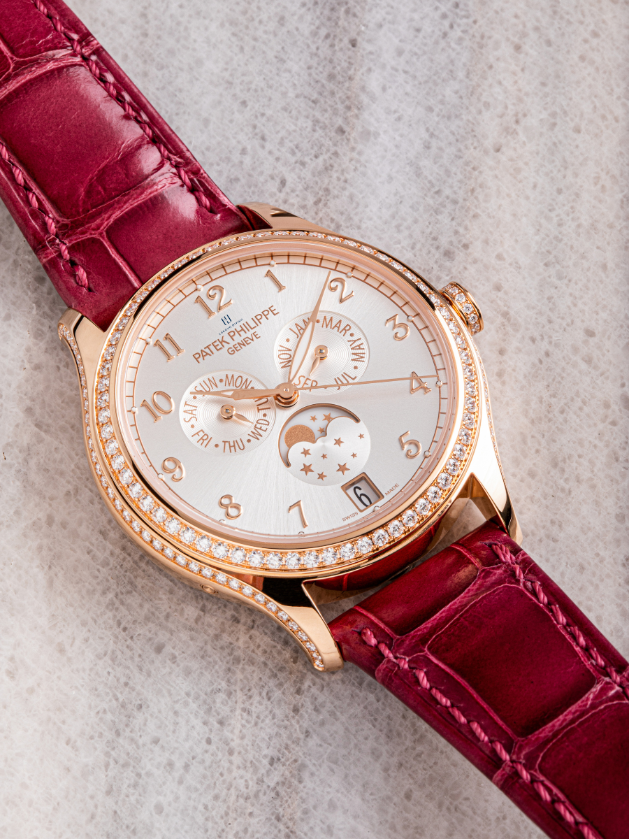 The image presents Patek Philippe 4947R-001 Rose Gold Watch with Annual Calendar, Diamond Case, and Alligator Strap.