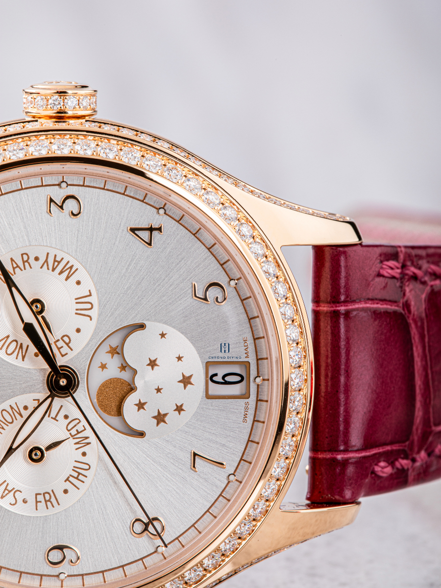 The image is on the right side view of Patek Philippe watch’s  brown strap and the portion of the white dial