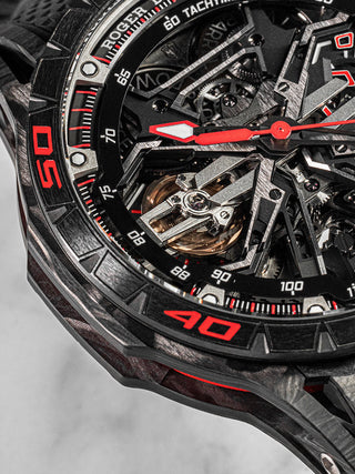 Front-facing view of the Roger Dubuis Excalibur Spider Flyback Chronograph with openworked dial, red detailing, and titanium case.