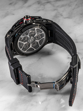 Skeleton dial Roger Dubuis Flyback Chronograph watch in a titanium case with sporty red highlights and a rubber strap – product display image.