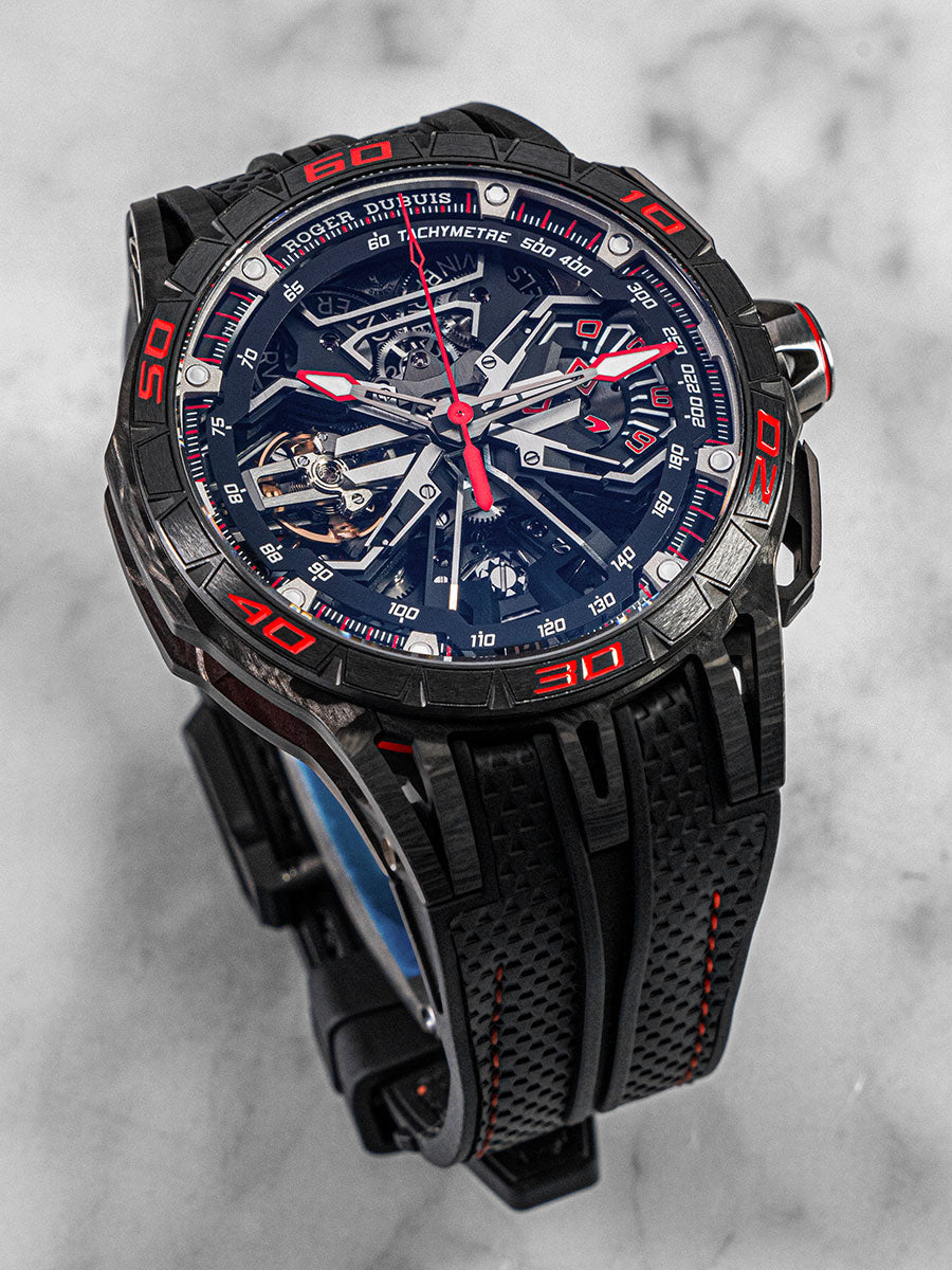 Roger Dubuis Excalibur Flyback watch featuring skeletonized mechanics, black strap, and sporty red accents – displayed on a clean white background.