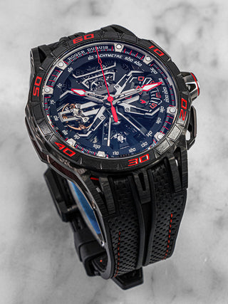 Roger Dubuis Excalibur Flyback watch featuring skeletonized mechanics, black strap, and sporty red accents – displayed on a clean white background.